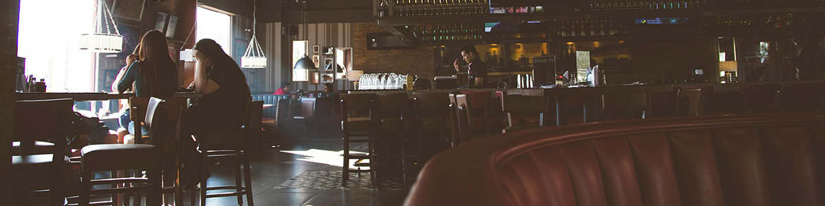Zoomed out picture of bartender behind bar