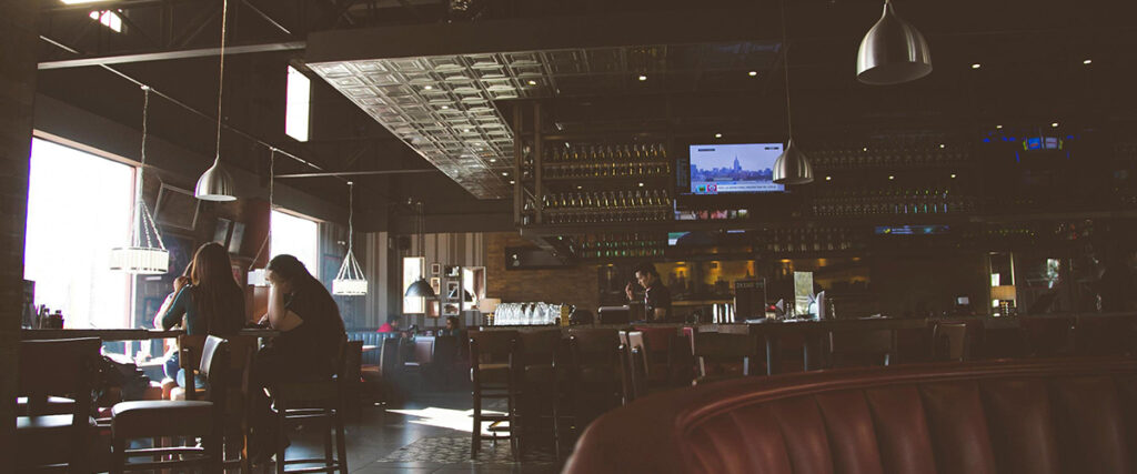 zoomed out picture of bartender behind bar